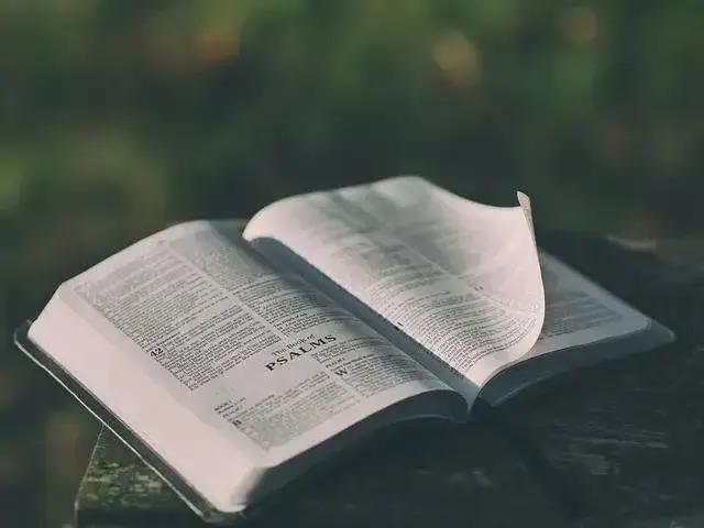 Open Bible laying on top of a table