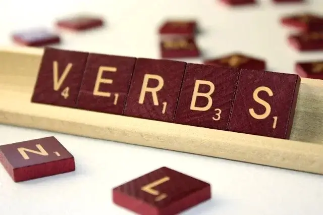 Photo of a scrabble board forming the words VERBS
