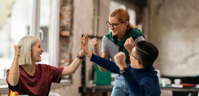 Three young people cheering up one of them