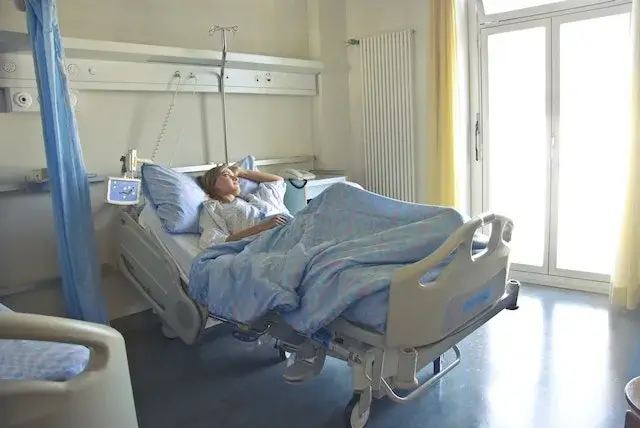 A Young Lady Hospitalized at a Hospital A young lady lying in a hospital bed.