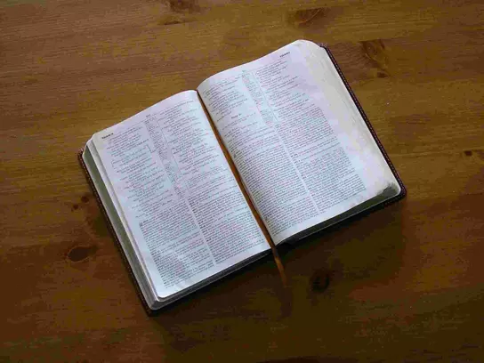 A photo of an open Bible lying on a table